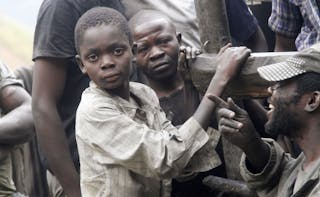 Boys working as artisanal miners take a break from panning for gold at the Marco gold mine in Mukungwe locality in Walungu terri