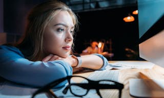 Portrait of tired businesswoman sitting at workplace late at night