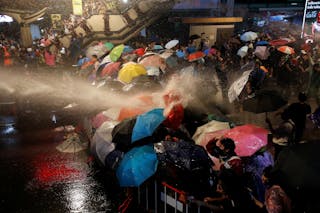 民眾用雨傘阻擋強力水柱的攻擊