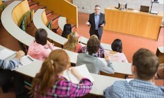 Elegant teacher with students sitting at the college lecture hall 大學 university