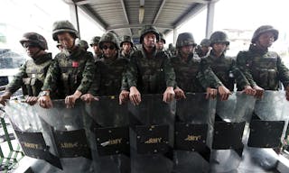 Armed with shields, Thai soldiers guard on an overpass to prevent anti-coup demonstration in Bangkok, Thailand Sunday, June 1, 2014. An anti-coup activist in Thailand called Friday for a weekend rally to defy the military government's ban on demonstrations, urging those opposed to the takeover to wear masks and be ready for cat-and-mouse chases with soldiers in the capital. (AP Photo/Wason Wanichakorn)