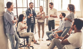 Successful young business people are talking and smiling during the coffee break in office