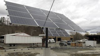 In this Thursday, April 23, 2015 photo, some of the solar trackers that provide power for the town of Norwich, Vt., face skyward in White River Junction, Vt. Norwich is the first community in the state where all municipal buildings get their electricity from the sun. Town officials said they want to do their part to help the state reach it's long-term goal of having 90 percent of the state's energy come from renewable sources by 2050. (AP Photo/Wilson Ring)