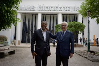 Okwui Enwezor, left, curator of the 56th edition of the Venice Biennale of Arts poses with Biennale President Paolo Baratta at the 56th Biennale of Arts in Venice, Tuesday, May 5, 2015. (AP Photo/Domenico Stinellis)