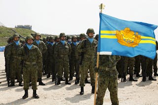 Soldiers of Japan's Self Defence Force stand at attention during the opening ceremony of a military base on the island of Yonagu