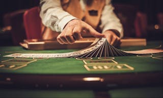 poker Croupier behind gambling table in a casino.