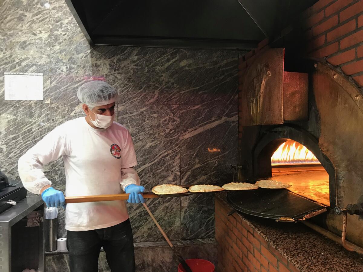 Worker tends to fire-brick oven