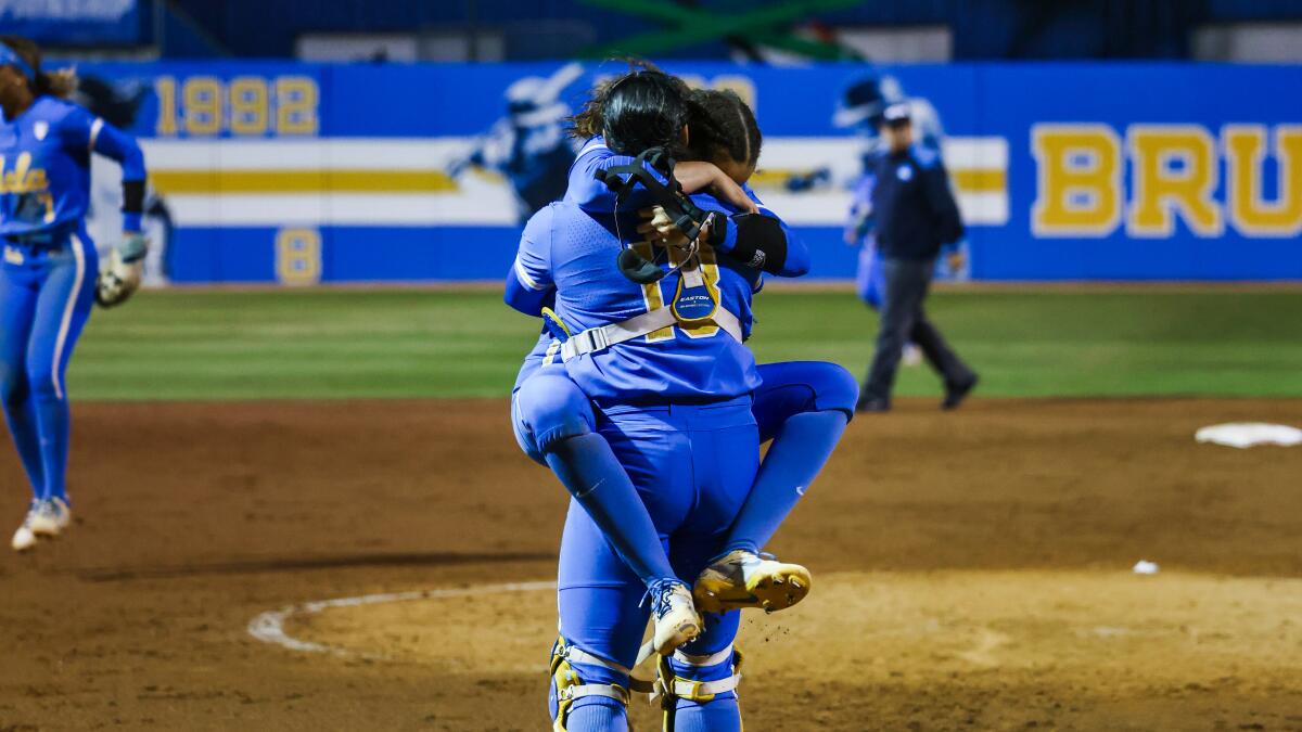 UCLA pitcher Taylor Tinsley jumps into the arms of catcher Sharlize Palacios.
