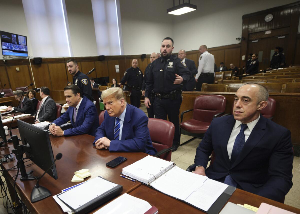 Former President Trump sits at a table at Manhattan criminal court in April.