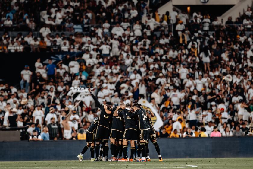 LAFC players huddle after securing a win over the Galaxy on Thursday, July 4, at the Rose Bowl in Pasadena.