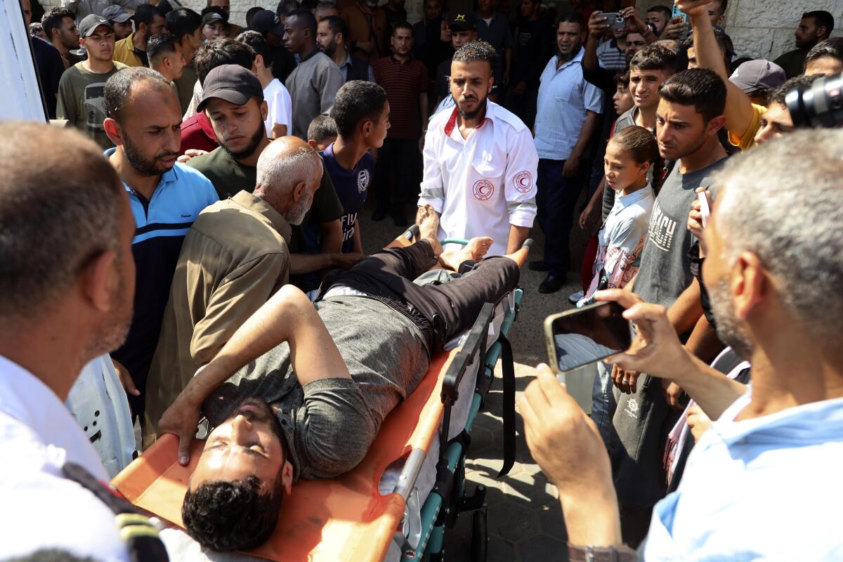 A Palestinian man wounded in an Israeli airstrike is brought to a Gaza Strip hospital.