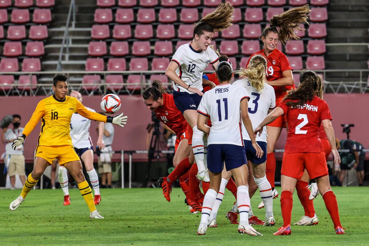 U.S. players try to hold back a Canada scoring attempt late in Monday's Olympic semifinal match.