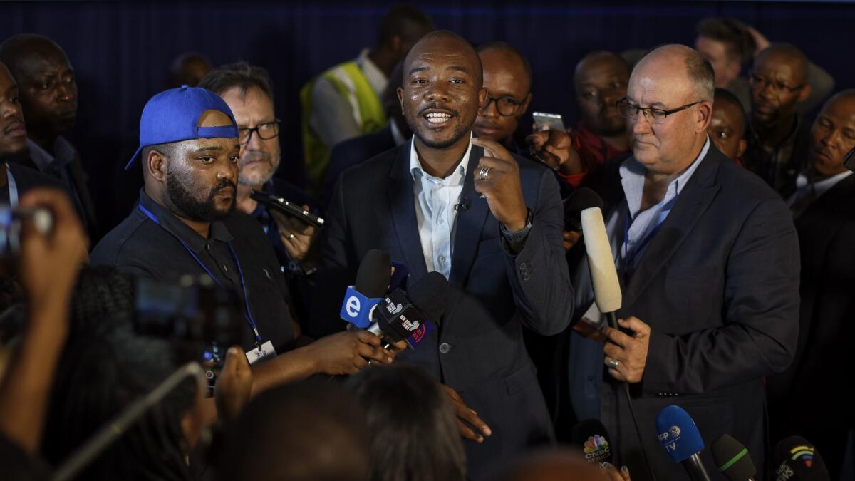 Mmusi Maimane, center, leader of the largest opposition party, the Democratic Alliance, speaks to the media in Pretoria, South Africa, on May 10, 2019.