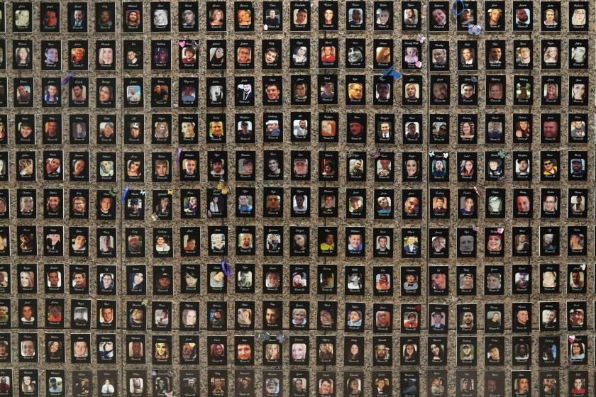 Photographs of people who had died from drugs are on display during the Second Annual Family Summit on Fentanyl at DEA Headquarters in Washington, Tuesday, Sept. 26, 2023. (AP Photo/Jose Luis Magana)