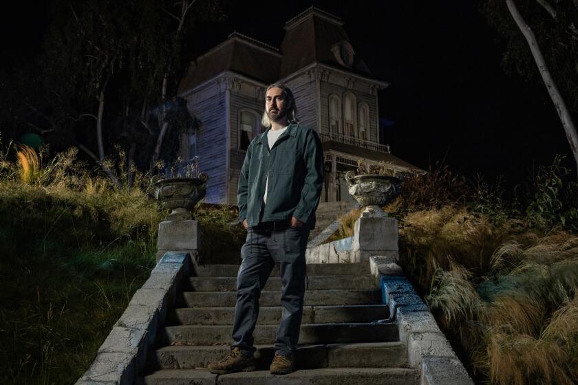 Los Angeles, CA - June 25: MAXXXINE director Ti West poses for a portrait in front of the famous "Psycho" house on the Universal Lot on Tuesday, June 25, 2024 in Los Angeles, CA. (Jason Armond / Los Angeles Times)