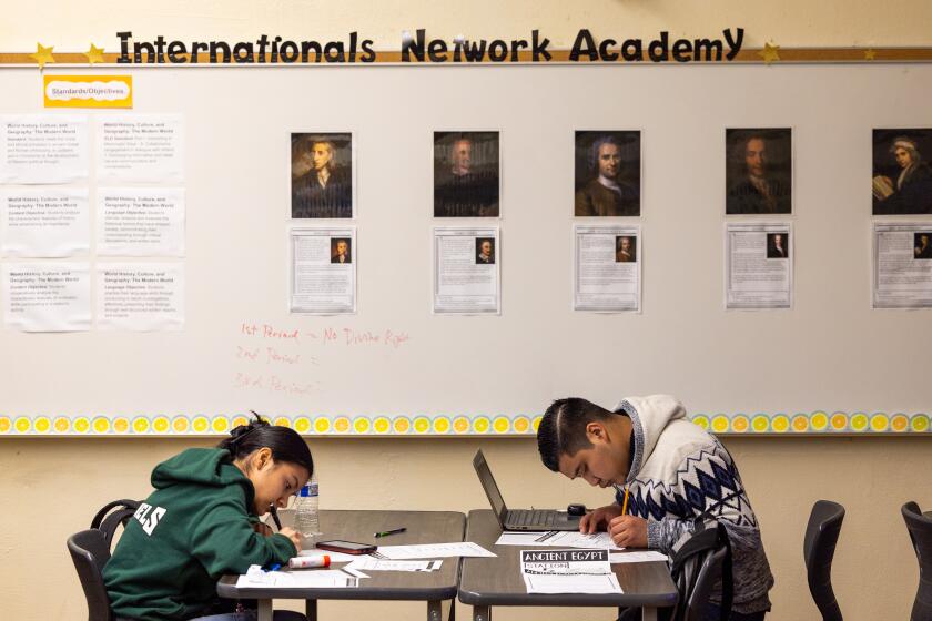 Los Angeles, CA - January 22: 10th grade world history students Leonara F., left and Walter C. work on their school work at The Internationals Network Academy at Belmont High School. The Internationals Network Academy was established to help immigrant children - most of whom are unaccompanied minors - get adjusted to the education system in L.A. Photo taken at Belmont High School in Los Angeles Monday, Jan. 22, 2024. (Allen J. Schaben / Los Angeles Times)