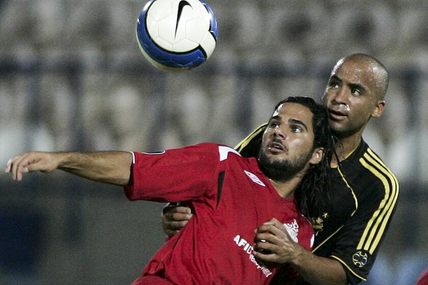 Hapoel Tel Aviv's Lior Asulin, front, vies for the ball with AIK Solna's Jimmy Tamadi during their UEFA Cup first round first leg soccer match at Bloomfield stadium in Tel Aviv, Israel, Thursday, Sep. 20, 2007. (AP Photo/Ariel Schalit)