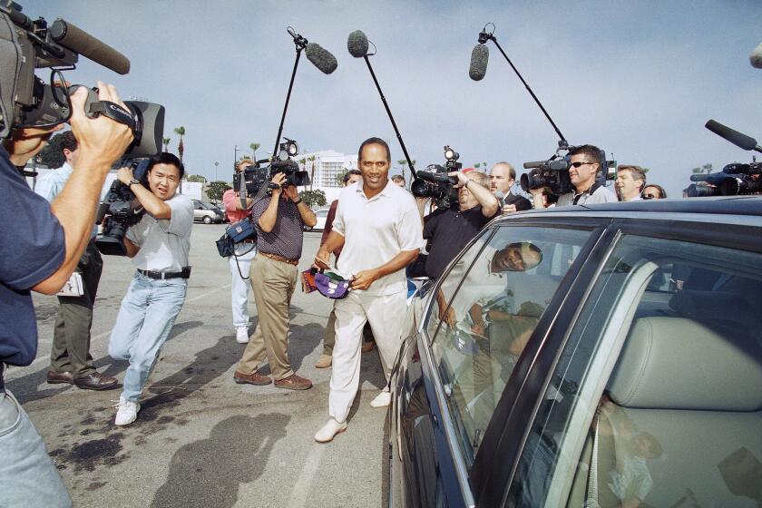 O.J. Simpson is surrounded by media as he departs Santa Monica Superior Court in Santa Monica, California on Thursday, May 15, 1997. (AP Photo/Nick Ut)