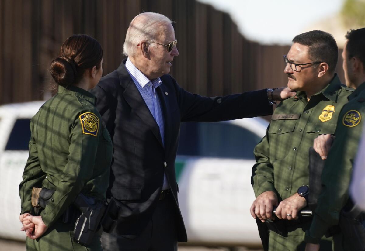 Joe Biden talks with two uniformed Border Patrol agents