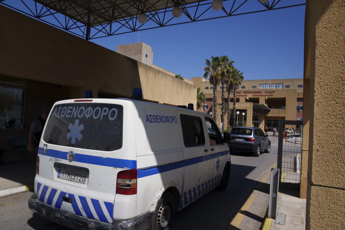 An ambulance drives through the entrance of a state-run hospital on the island of Rhodes in Greece