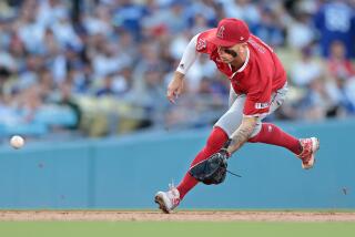LOS ANGELES, CALIFORNIA- Angels shortstop Zach Neto fields a ball against the Dodgers.