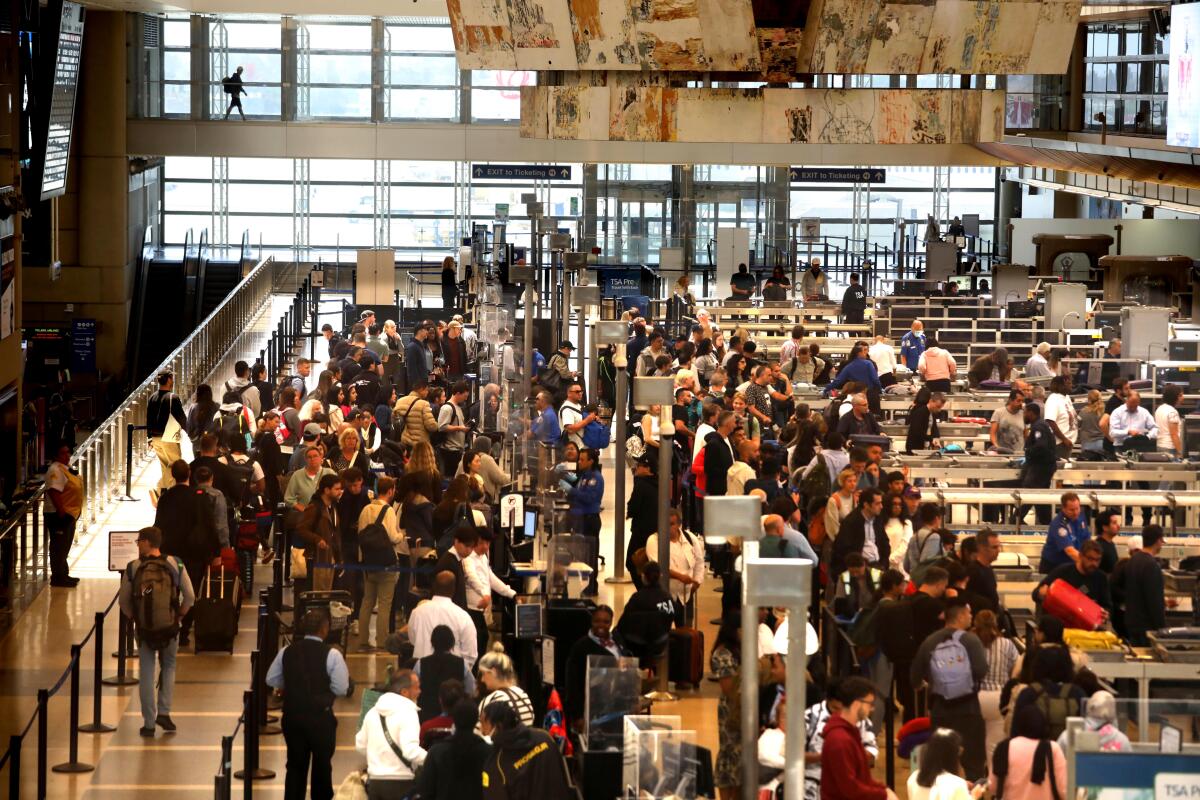 Travelers pass through security lines at Tom Bradley International Terminal at LAX