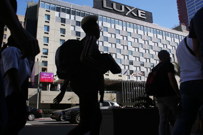 LOS ANGELES, CA-MARCH 14, 2019: People walk by The Luxe City Center Hotel which has been a favorite spot for L.A. politicians to hold fundraisers on March 14, 2019, in Los Angeles, California. The nine-story hotel is also one of several L.A. businesses to come under scrutiny from the FBI, which has been investigating the activities of Councilman Jose Huizar and several other city officials. (Photo By Dania Maxwell / Los Angeles Times)