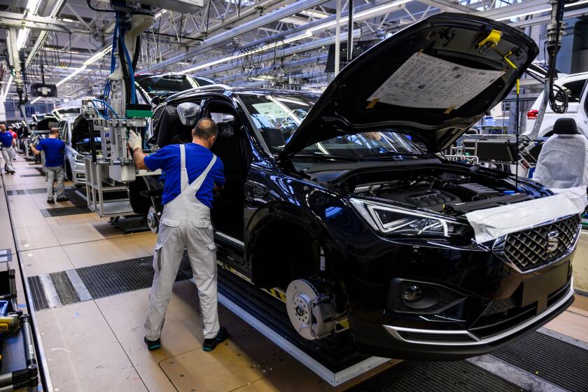 A worker on a production line at German car manufacturing giant Volkswagen's headquarters in Wolfsburg, Germany. Ford, Honda, Volkswagen and BMW have reached a deal with California air regulators to gradually increase fuel efficiency standards