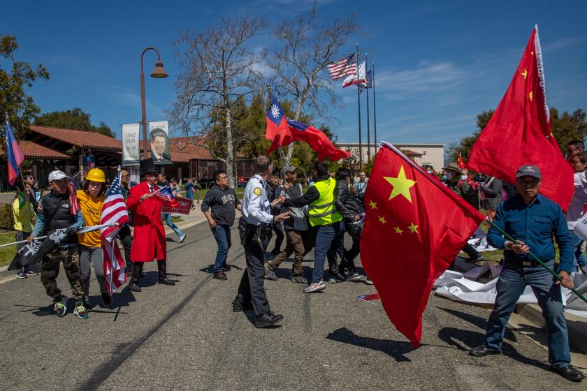 SIMI VALLEY, CA - APRIL 05: Scuffle breaks out between supporters of China and supporters of Taiwan on the arrival of Taiwan President Tsai Ing-wen at Ronald Reagan Presidential Library on Wednesday, April 5, 2023 in Simi Valley, CA. (Irfan Khan / Los Angeles Times)