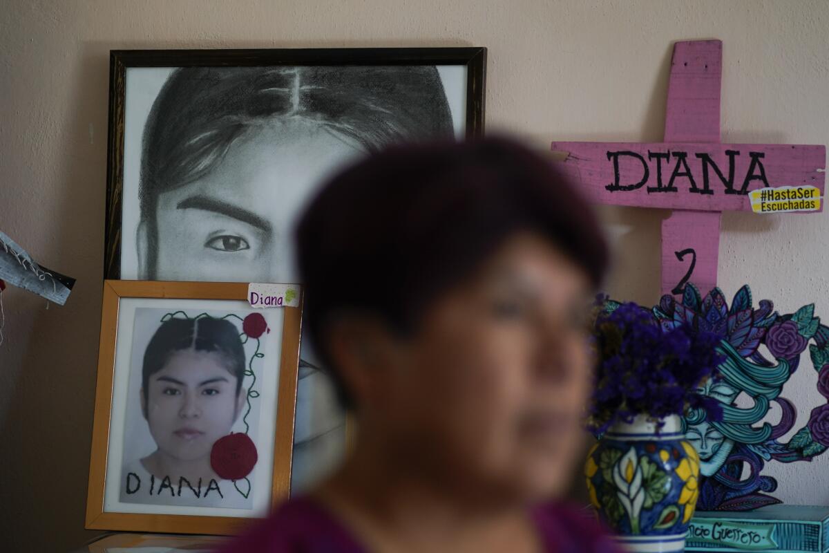 Photographs of Diana Velazquez adorn a small altar.