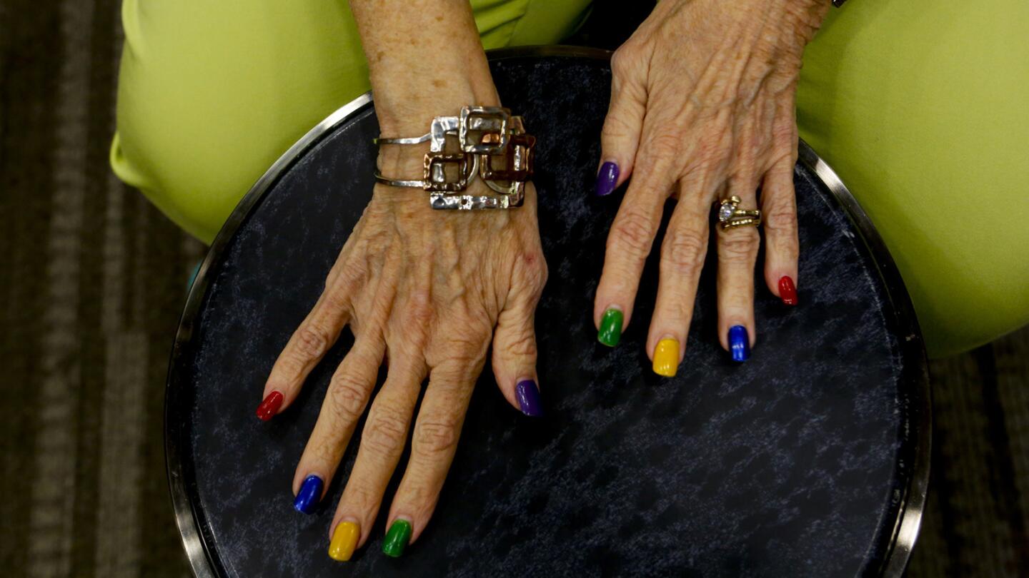 Vicki Finn keeps the rhythm during a drum circle class at the NoHo Senior Arts Colony. She calls her hands "happy hands" because her colorful nail polish makes people smile.