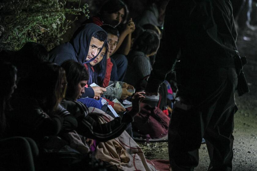 Barrett Junction, CA, Tuesday, June 4, 2024 - Asylum seekers wait to board border patrol vehicles near Campo Rd. after hiking 9 plus hours from the US/Mexco border over Mt. Cuchoma. (Robert Gauthier/Los Angeles Times)