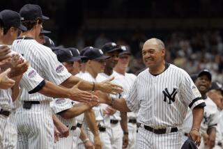 Former Yankees player Reggie Jackson greets other ex-players before an old-timers baseball game at Yankee Stadium