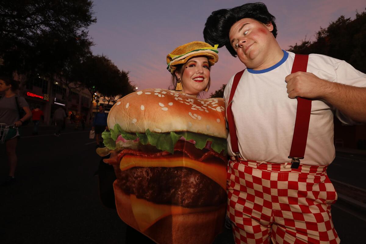 Stephanie Dobies, dressed as a hamburger, and Aaron Marsh, as Bob's Big Boy, at the annual Halloween Carnaval.