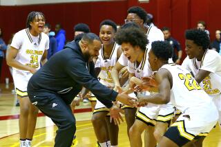King/Drew coach Lloyd Webster celebrate with his players after winning City Section Open Division championship.