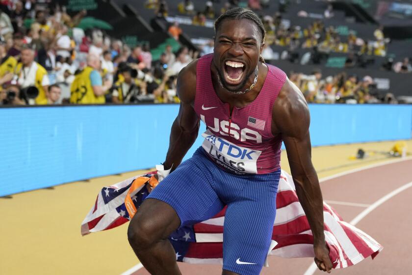 Noah Lyles, of the United States, celebrates after winning the gold medal in the men's 100-meter final during the World Athletics Championships in Budapest, Hungary, Sunday, Aug. 20, 2023. (AP Photo/Matthias Schrader)