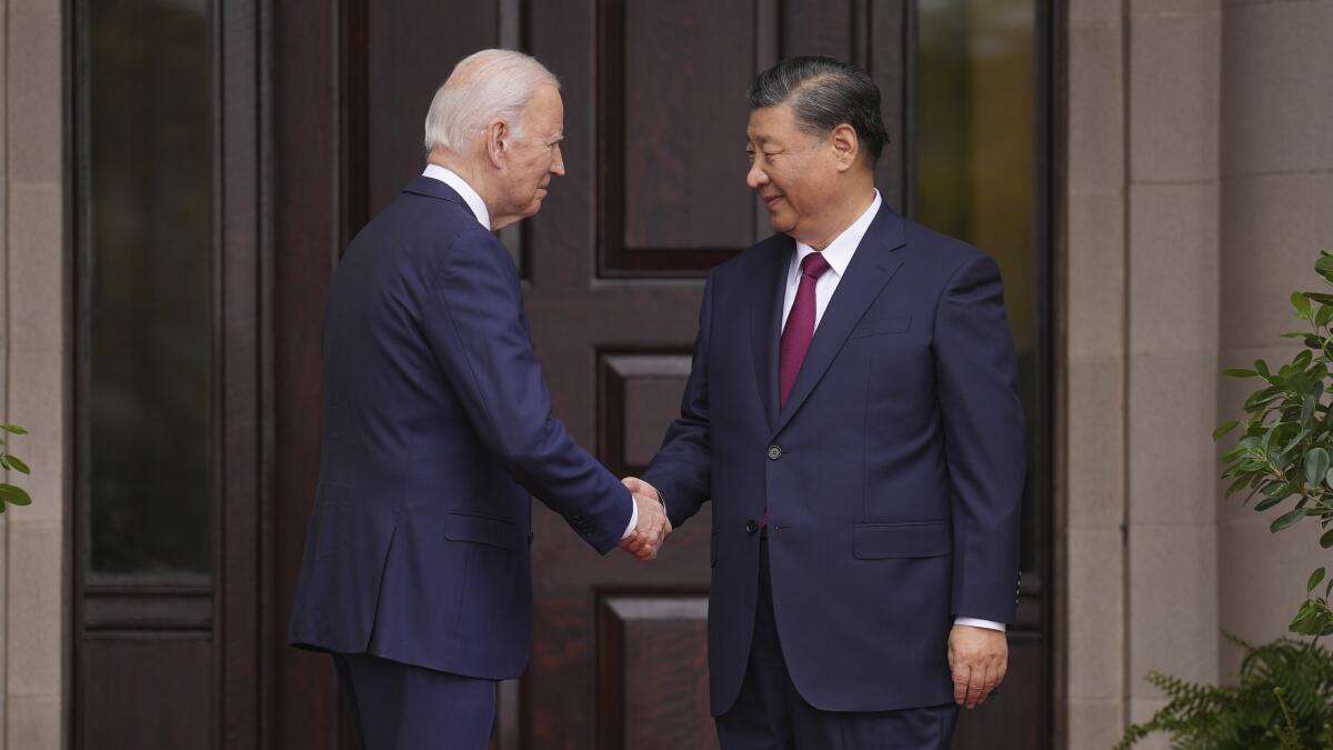 President Biden shakes hands with Chinese President Xi Jinping.