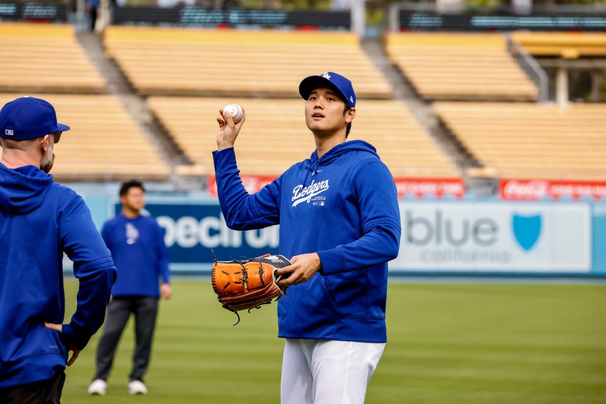 Shohei Ohtani does throws the ball at Dodger Stadium after he addressed allegations against his ex-interpreter on Monday