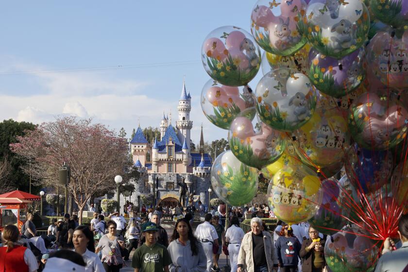 Anaheim, CA - March 11: Visitors walk down Main Street, U.S.A. at Disneyland Monday, March 11, 2024. (Allen J. Schaben / Los Angeles Times)
