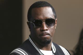 Sean "Diddy" Comb wearing a dark jacket with white stripes and big sunglasses with a somber expression on his face