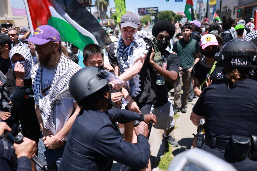 Los Angeles Police Department (LAPD) officers clash with anti-Israel protesters gathered outside the Adas Torah Orthodox Jewish synagogue in Los Angeles, June 23, 2024. (Photo by DAVID SWANSON / AFP) (Photo by DAVID SWANSON/AFP via Getty Images)