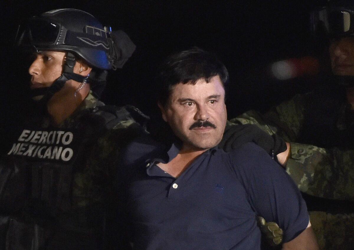 Drug kingpin Joaquin "El Chapo" Guzman is escorted to a helicopter at Mexico City's airport in 2016.