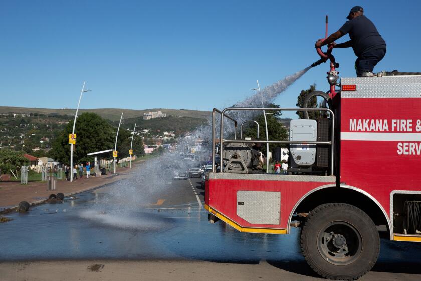 April 27, 2019. The fire brigade washed away faeces that had been dumped in the main road ahead of President Cyril Ramaphosas visit. South African President Cyril Ramaphosa visited the town of Makhanda (Formerly known as Grahamstown) on Freedom Day. Ironically the municipality is one of South Africa's worst managed. Roads are potholed, water is undrinkable, refuse is not removed. Picture: James Oatway for the Los Angeles Times.