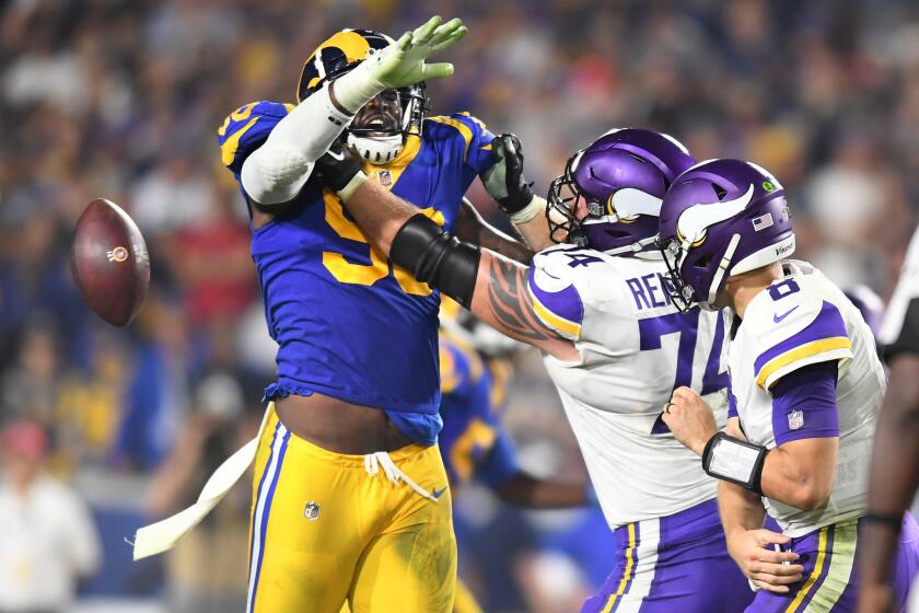 Rams defensive lineman Michael Brockers forces Vikings quarterback Kirk Cousins into a fumble late in the 4th quarter. The Rams recovered to preserve the win.