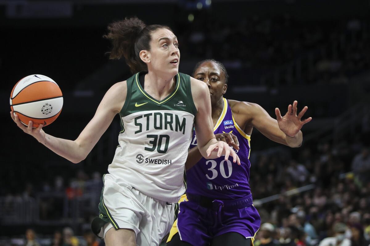 Seattle Storm's Breanna Stewart handles the ball in the first half ahead of Sparks' Nneka Ogwumike.