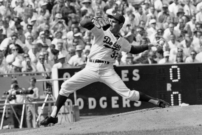 FILE - In this Oct. 6, 1966 file photo, Los Angeles Dodgers' Sandy Koufax, pitches against the Baltimore Orioles in game two of the World Series baseball game in Los Angeles.In 1965, Koufax didn't pitch the Dodgers' Series opener at Minnesota because of Yom Kippur and lost to Jim Kaat the following day. Koufax pitched a four-hit shutout on three days' rest to win Game 5, then came back with a three-hit shutout on two days' rest to win Game 7. (AP Photo/File)