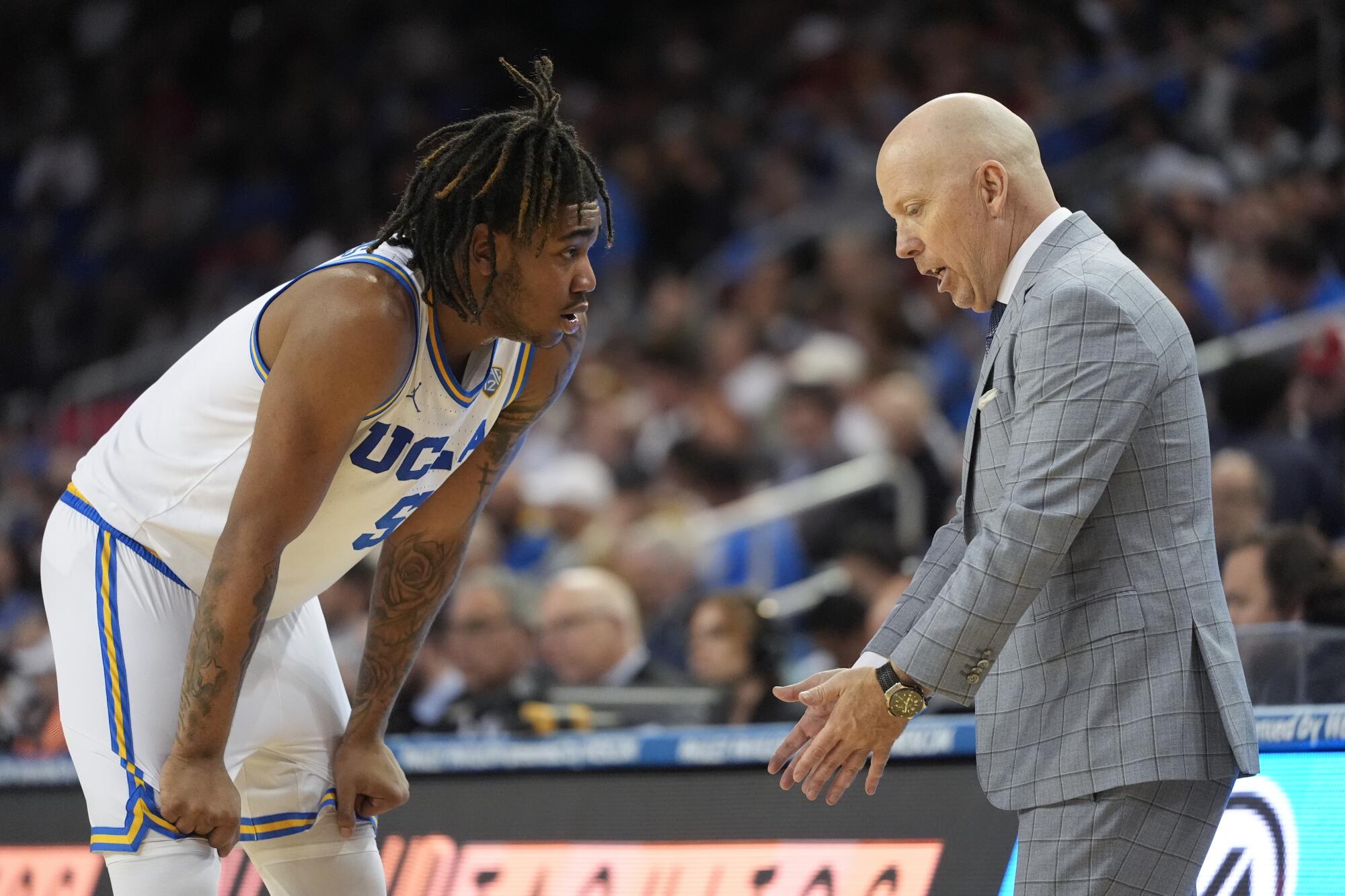 Brandon Williams talks to UCLA coach Mick Cronin during a game against Arizona at Pauley Pavilion in March.