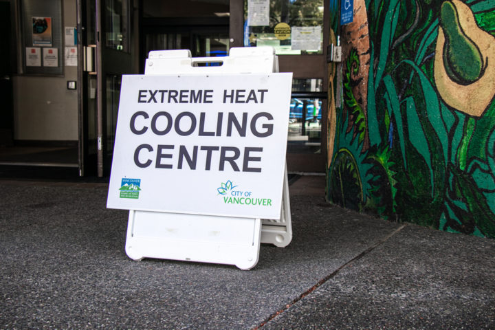 Vancouver, Canada - July 29,2021: View of sign Extreme Heat Cooling Centre at the entrance of Denman Community Centre — Photo by Margarita_Young