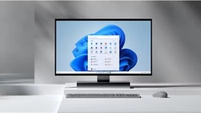 Microsoft desktop with the blue bloom on the screen sitting on a white table