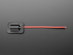 Overhead shot of sewable DC jack connector with black and red wires.